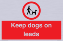 dogs-on-lead-symbol-with-black-text-on-white-background~